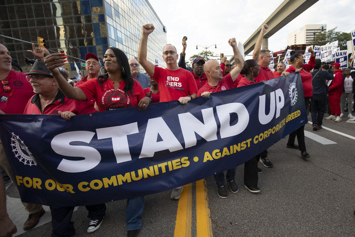 United Auto Workers President Shawn Fain marches with UAW members through downtown Detroit on Friday after a rally in support of UAW members as they strike against the automakers Ford, General Motors and Stellantis.