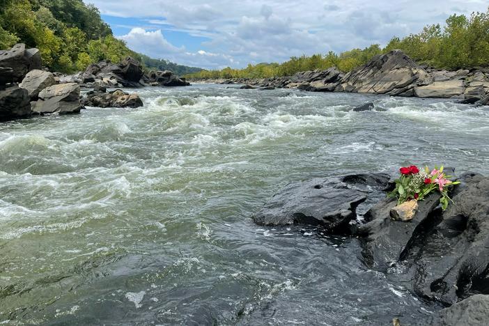 Washington-area whitewater kayakers lay flowers on the Potomac's Little Falls rapid near the rocks that entrapped visiting kayaker Ella Mills.