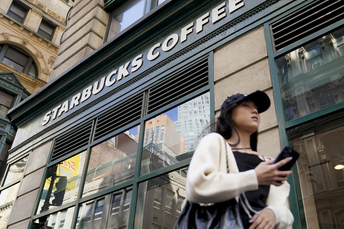 Pedestrians pass a Starbucks in the Financial District of Lower Manhattan in New York on June 13.