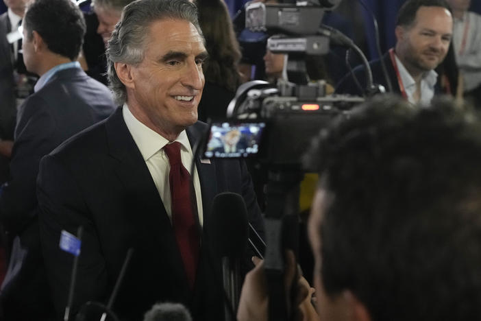 North Dakota Gov. Doug Burgum speaks to reporters in the spin room after a Republican presidential primary debate on Aug. 23.