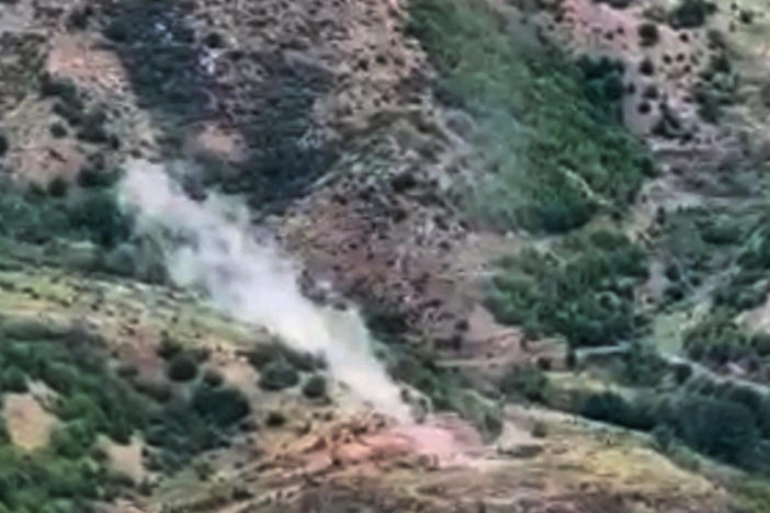 In this photo taken from video released by Defense Ministry of Azerbaijan on Tuesday, Sept. 19, 2023, smoke rises over an area which Azerbaijan says hosts Armenian forces' positions in the breakaway territory of Nagorno-Karabakh in Azerbaijan.