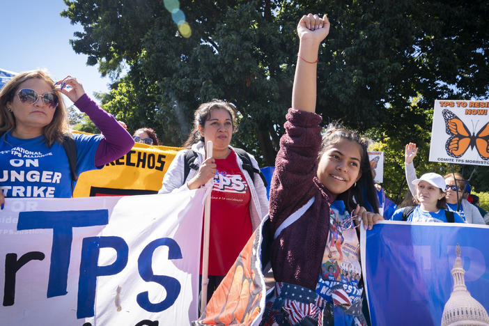 Marilyn Miranda, 12, of Washington raises her hand up during a protest for an extension of the Temporary Protected Status in September 2022 in Washington, D.C.