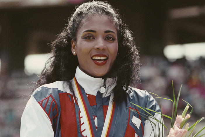 Florence Griffith-Joyner celebrates with her gold medal after winning the Women's 100 meters final event during the 1988 Summer Olympic Games in Seoul, South Korea.