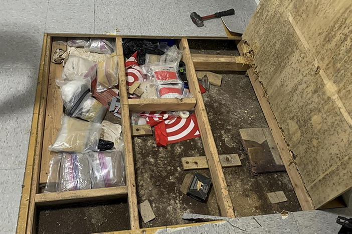 In this photo provided by the New York City Police Department, a trap door leans open over narcotics, including fentanyl, and drug paraphernalia stored in the floor of a day care center, Thursday, Sept. 21, 2023, in New York.
