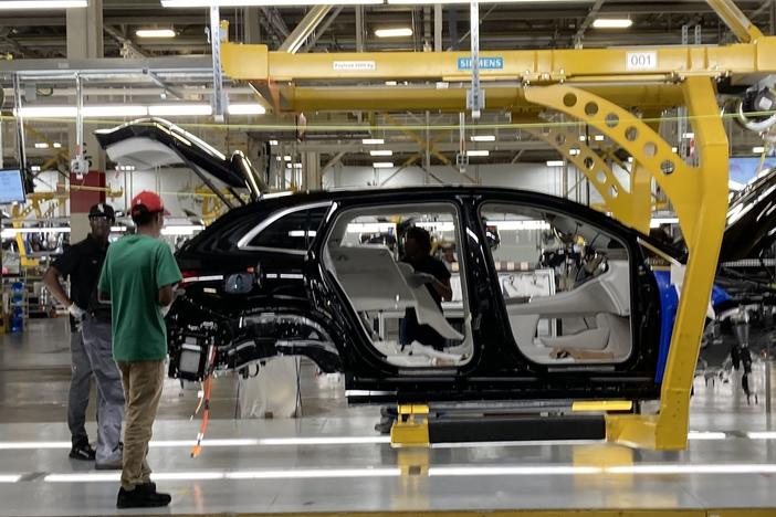 Autoworkers at Mercedes plant in Vance, Ala., assemble an all-electric SUV.