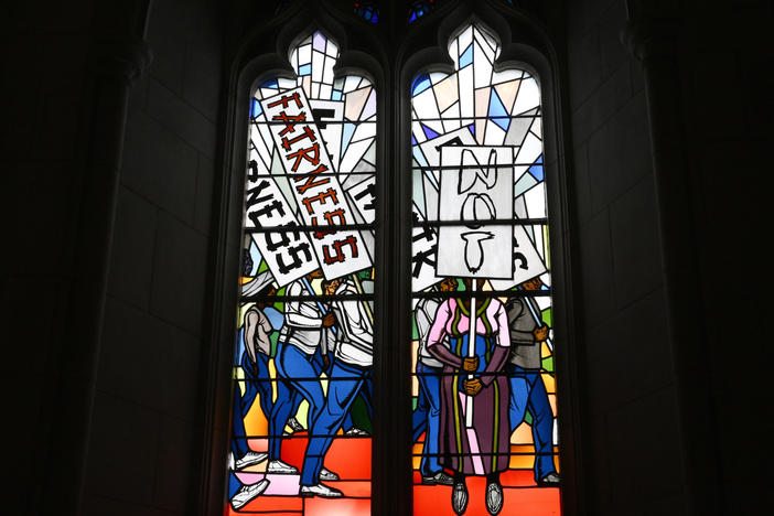 Light shines through new stained-glass windows with a theme of racial justice during an unveiling and dedication ceremony at the Washington National Cathedral for the windows on Saturday, Sept. 23 in Washington.