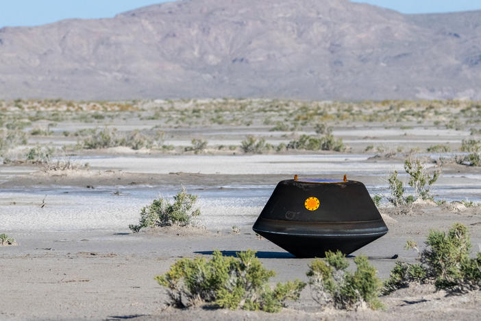 The sample return capsule from NASA's OSIRIS-REx mission is seen shortly after touching down in the desert at the Department of Defense's Utah Test and Training Range.
