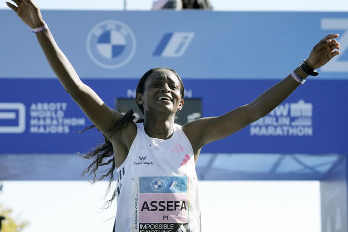 Ethiopia's Tigist Assefa celebrates as she crosses the finish line to win the women's division of the Berlin Marathon in world record time in Berlin, Germany, Sunday, Sept. 24, 2023.