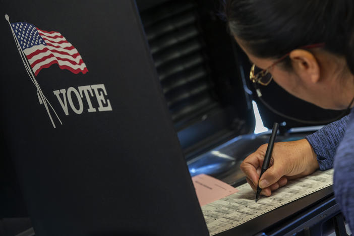 A woman marks her ballot at a polling center in Albuquerque, N.M., on Nov. 8, 2022. Republicans in the state are challenging the congressional map that was used for that election.