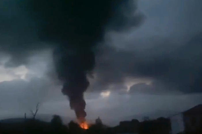 This grab taken from video distributed by Siranush Sargsyan's Twitter account on Monday, Sept. 25, 2023, shows smoke rising after a fuel depot explosion near Stepanakert, Nagorno-Karabakh.