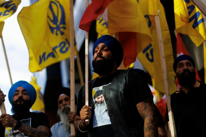 People hold flags during a Sikh rally outside the Indian Consulate in Toronto to raise awareness in the wake of the Canadian prime minister's comments alleging Indian government agents were potentially involved in the June killing of Sikh separatist Hardeep Singh Nijjar in British Columbia, on Monday.