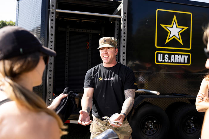 Staff Sgt. Joshua Spearman talks to fairgoers at the Army recruitment tent at the Minnesota State Fair in Falcon Heights, Minn., on August 31.