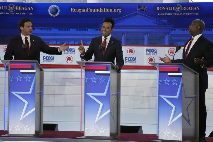 From left to right, Florida Gov. Ron DeSantis, businessman Vivek Ramaswamy and Sen. Tim Scott, R-S.C., argue a point during a Republican presidential primary debate hosted by FOX Business Network and Univision on Wednesday.