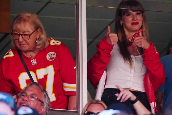 Donna Kelce, wearing her son Travis' No. 87 jersey, and Taylor Swift are seen during the Kansas City Chiefs' game with the Chicago Bears in Kansas City, Missouri. Sales of Kelce's jersey soared after Swift appeared at the game.