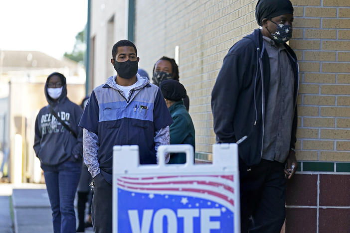 People line up to vote at the Dr. Martin Luther King Jr. Charter Elementary School in New Orleans in 2020.