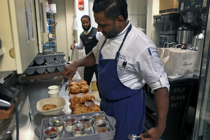 Chef Zaid Khan prepares food in Boston to be sold through the app Too Good To Go. The app helps establishments sell food that would otherwise go to waste.
