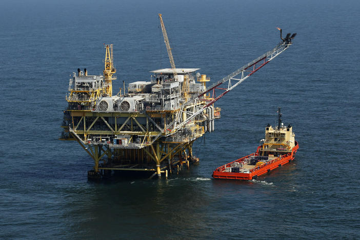 This April 10, 2011, file photo, shows a rig and supply vessel in the Gulf of Mexico, off the coast of Louisiana. The Biden administration has proposed up to three oil and gas lease sales in the Gulf of Mexico over the next five years.