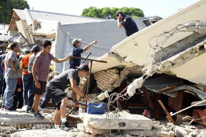 Rescue workers search for survivors amid debris after the roof of a church collapsed during a Sunday Mass in Ciudad Madero, Mexico, Sunday, Oct. 1, 2023.