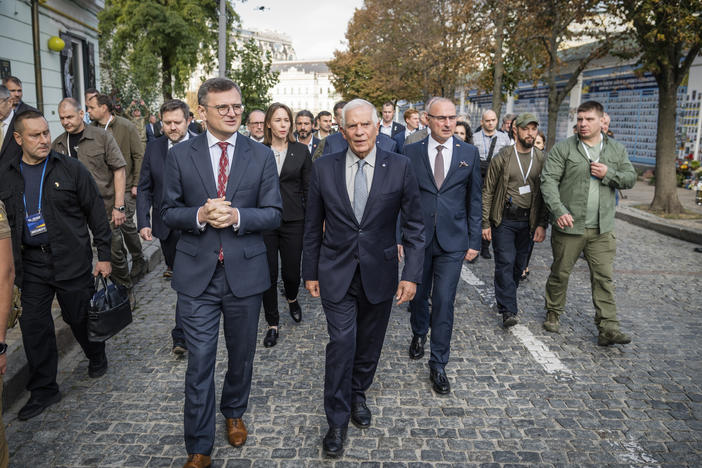 Ukrainian Foreign Minister Dmytro Kuleba (center left) and European Union foreign policy chief Josep Borrell visit a monument to fallen defenders of Ukraine in Kyiv, Monday. Borrell and EU foreign ministers have gathered in Kyiv in a display of support for Ukraine's fight against Russia's invasion.