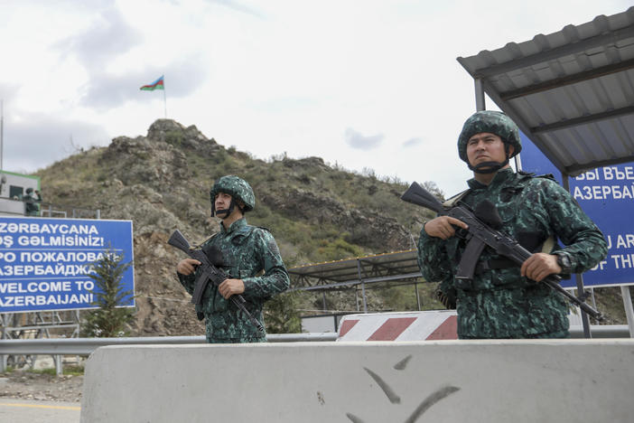 Azerbaijani servicemen guard the Lachin checkpoint in Azerbaijan on Sunday.