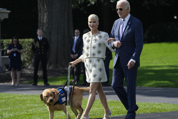 President Joe Biden walks with actress Selma Blair and Blair's service dog Scout as they arrive for an event to celebrate the Americans with Disabilities Act on the South Lawn of the White House on Monday.