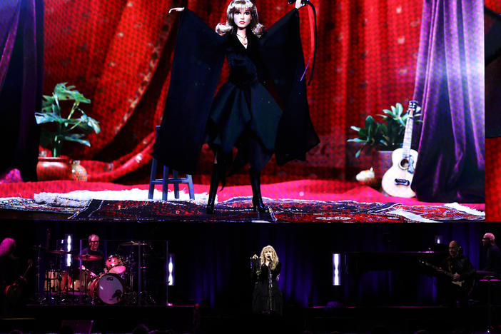 Stevie Nicks stands under an image of her new Barbie doll during a concert at New York City's Madison Square Garden on Sunday.