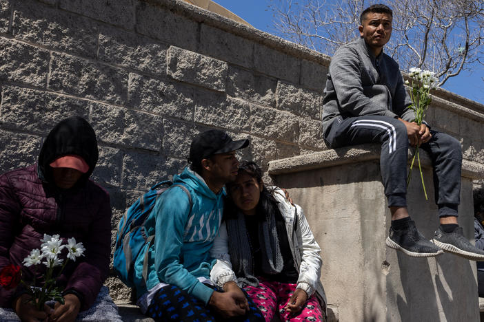 Hundreds of migrants go to a Mexican migration office seeking information about victims of a fire inside a migrant detention center in Ciudad Juárez, Mexico, on March 28.