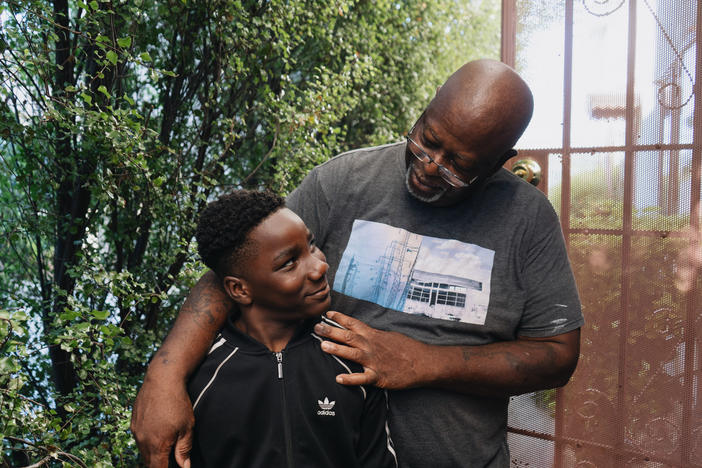 Ziare Gearring (left) and his grandfather Ricky Brown pose for a portrait outside of their home in Los Angeles. The 65-year-old retired handyman had already been struggling, and taking in three grandsons after his ex-wife's sudden death has put him thousands of dollars behind on rent and utilities.