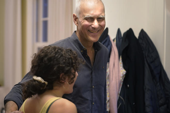 Moungi Bawendi of MIT, one of the 2023 winners of the chemistry Nobel Prize, embraces his step-daughter Julia Teller (left) at their home in Cambridge, Mass.
