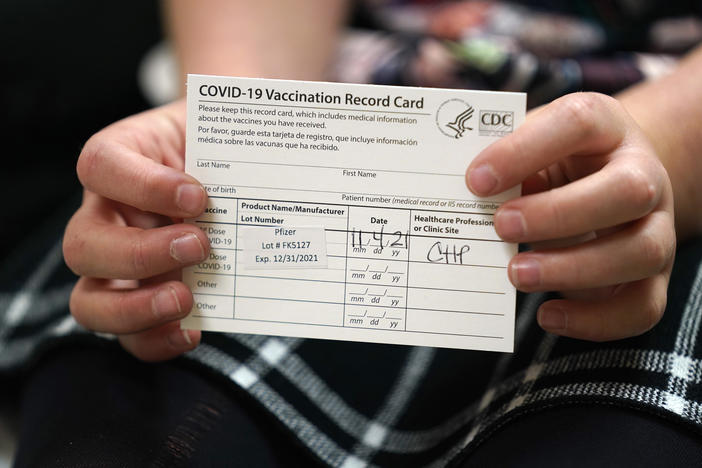 9 year-old Josie Murdoch holds her vaccination card at Chapel Hill Pediatrics and Adolescents after being innoculated with the Pfizer child COVID-19 vaccination in Chapel Hill, N.C., Thursday, Nov. 4, 2021.