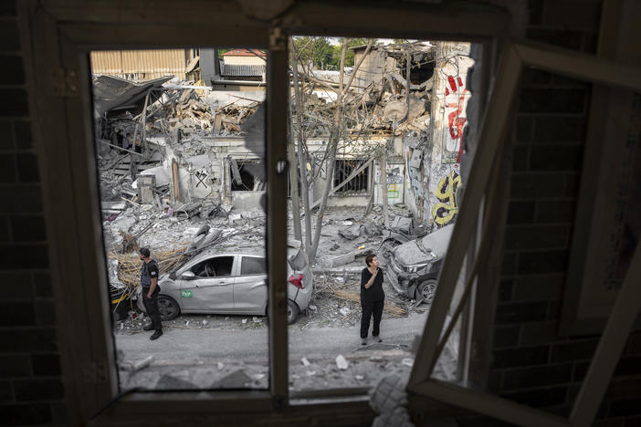 Sun., Oct. 8: Israelis inspect the rubble of a building a day after it was hit by a rocket fired from the Gaza Strip, in Tel Aviv, Israel.