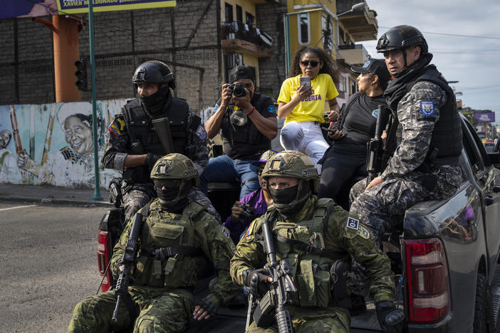 Soldiers patrol from on top of an armored vehicle as supporters of presidential candidate Daniel Noboa, of the National Democratic Action Alliance political party, attend a rally downtown in Esmeraldas, Ecuador, Friday, Oct. 6, 2023.