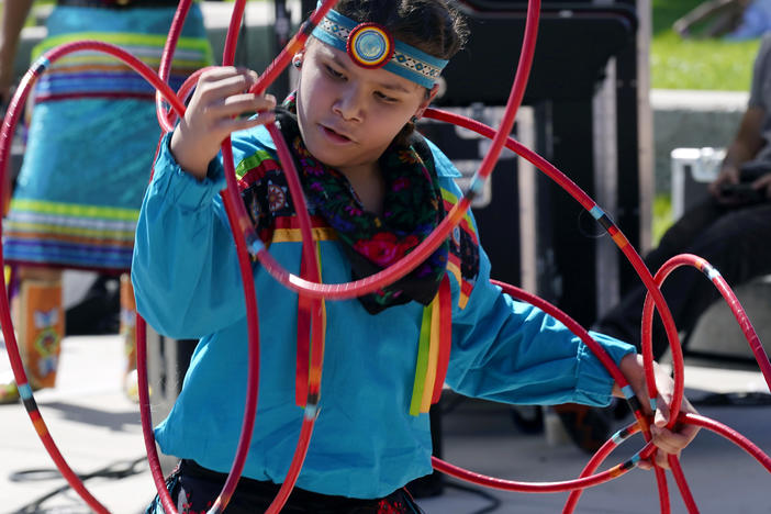 A performer from the Native American Hoop Dance of Ballet Arizona dances at an Indigenous Peoples Day festival Monday, Oct. 9, 2023, in Phoenix.