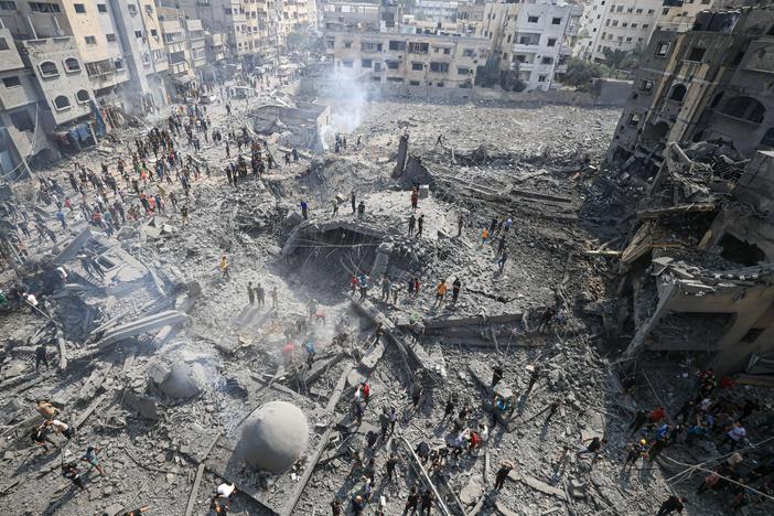 Palestinians inspect the damage following an Israeli airstrike on the Sousi mosque in Gaza City on Monday.