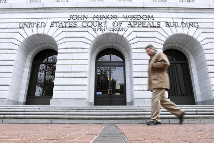 A person walks in front of the 5th U.S. Circuit Court of Appeals in New Orleans in 2015.