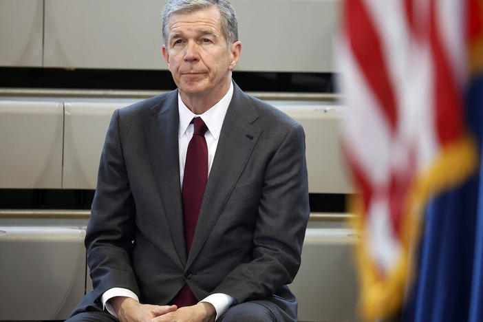 North Carolina Gov. Roy Cooper listens as Democratic gubernatorial candidate Josh Stein speaks at a rally Tuesday at Shaw University in Raleigh, N.C.