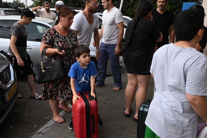 A family of survivors is taken by volunteer drivers from their home.