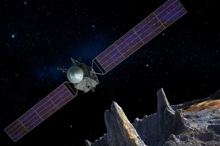 An artist's conception of the Psyche spacecraft approaching an asteroid that's largely composed of metal.
