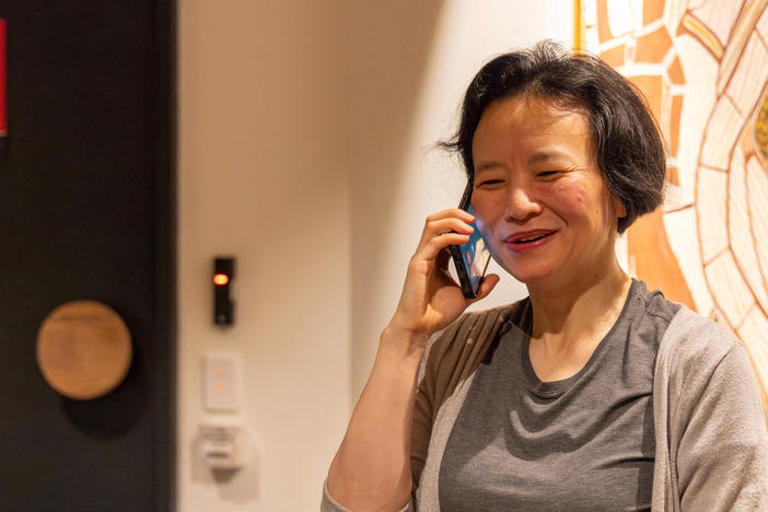 Australian journalist Cheng Lei speaks on the phone, on arrival at Melbourne Airport in Melbourne, October 11, 2023.