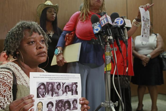 Black Coalition Fighting Back Serial Murders members Suzette Shaw, left, holding photos of 10 victims, and Margaret Prescod, at podium, join relatives of victims speaking after the sentencing for Lonnie Franklin Jr., a convicted serial killer known as the "Grim Sleeper," in Los Angeles Superior Court in August 2016.