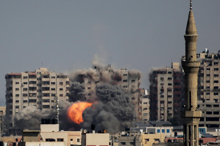 Israeli forces strike a residential tower in Gaza City on Thursday.