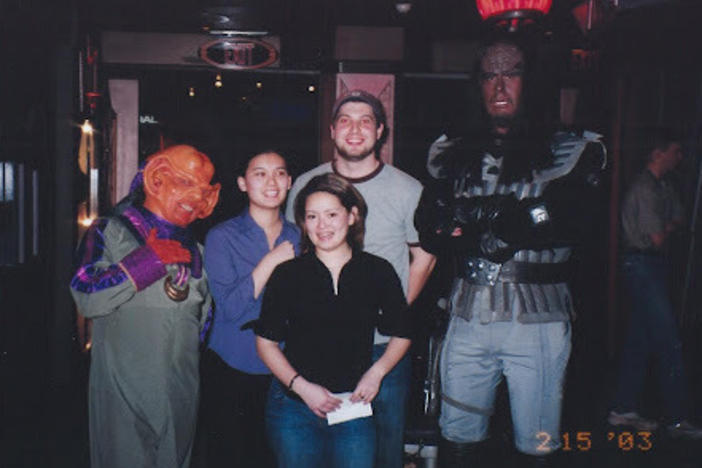 Regina (the author) shortly after she got a bachelor's degree in physics. Regina, her sister Maili, and Maili's future husband Max are standing next to a Klingon to the right and a Ferengi the left.