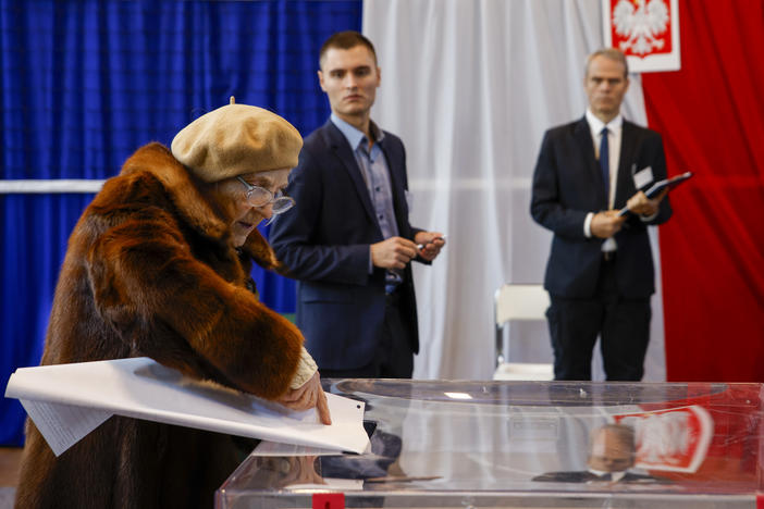 A woman casts her ballot during parliamentary elections in Warsaw, Poland, on Sunday, Oct. 15, 2023. The outcome of the election will determine whether the right-wing Law and Justice party will win an unprecedented third straight term or whether a combined opposition can win enough support to oust it.