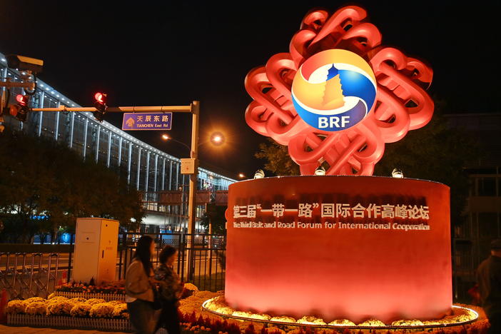 People walk past a decorative installation for the third Belt and Road Forum for International Cooperation on Sunday in Beijing.