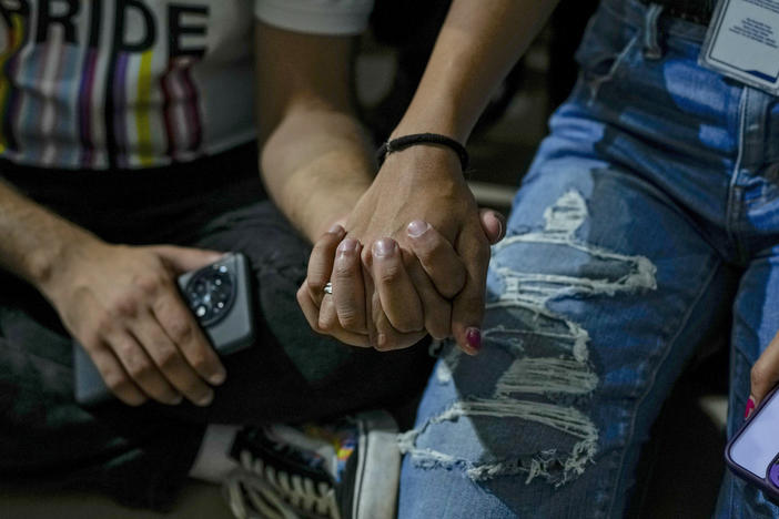 LGBTQ community supporters and members hold hands as they watch the Supreme Court verdict on petitions that seek the legalization of same-sex marriage, in Mumbai, India, Tuesday. According to a Pew survey, acceptance of homosexuality in India increased by 22 percentage points to 37% between 2013 and 2019.