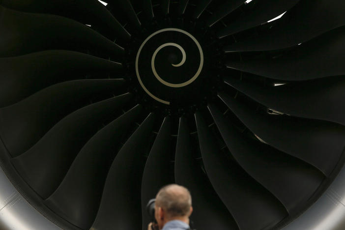 A visitor takes a photo of the Rolls-Royce jet engine of the Airbus A350-1000 parked at the static display area during the Singapore Airshow on Feb. 7, 2018, in Singapore.