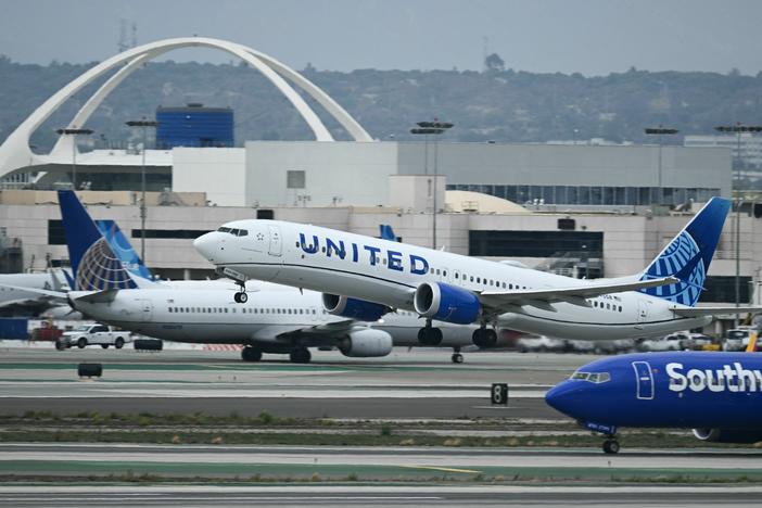 A United Airlines Boeing 737 airplane passes a Southwest Airlines jet while taking off from Los Angeles International Airport on September 11, 2023.