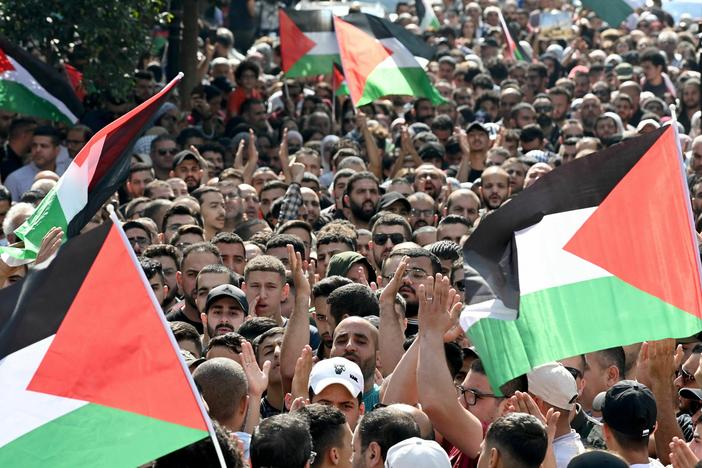 Palestinians wave the national flag during a demonstration in the city of Ramallah in the West Bank on Wednesday, Oct. 18, 2023, protesting an explosion on a Gaza hospital which killed hundreds a day earlier.