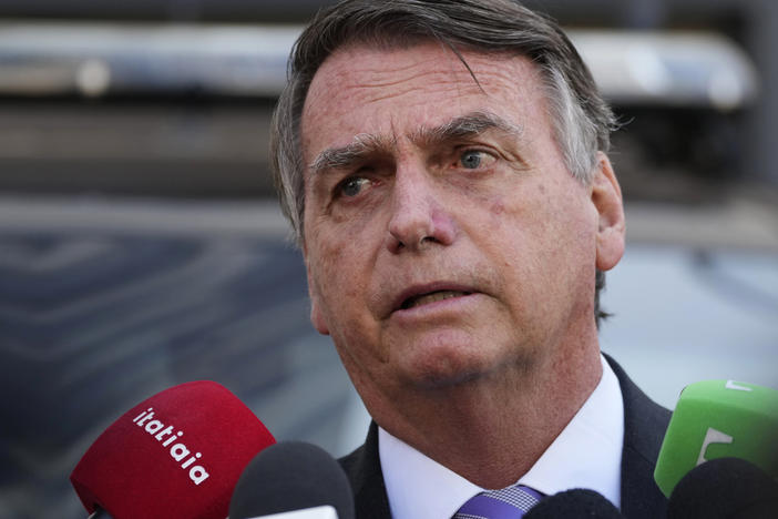 Brazil's former President Jair Bolsonaro speaks to the press as he leaves the Federal Police headquarters where he gave testimony about his actions related to the Jan. 8 attacks on government buildings in the capital, in Brasilia, Brazil, Wednesday, Oct. 18, 2023.