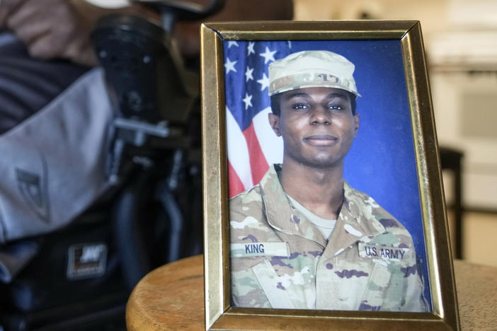 A portrait of Army Pvt. Travis King is displayed as his grandfather, Carl Gates, talks about his grandson on July 19, 2023, in Kenosha, Wis.